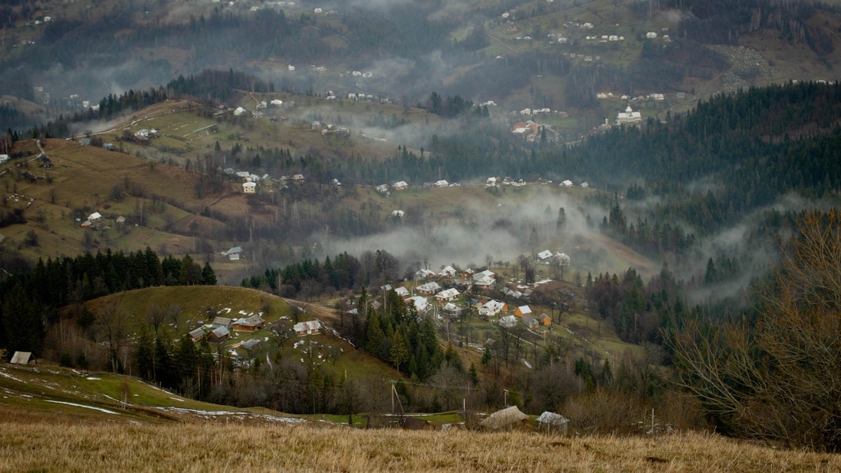 a view of a village in the mountains